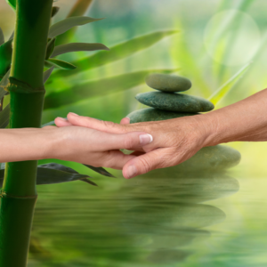 Two hands reaching out and touching each other on a green tranquil background